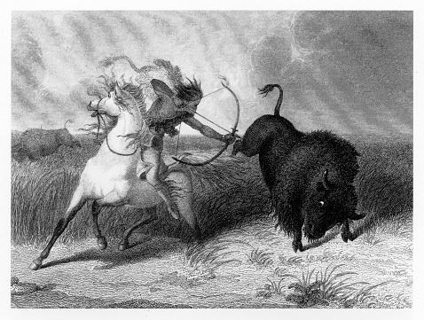 Beautifully Illustrated Antique Engraved Victorian Illustration of American Indians Hunting Bison Engraving, 1887. Source: Original edition from my own archives. Copyright has expired on this artwork. Digitally restored.