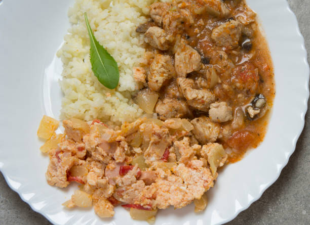 istock Pork meat with rice mushroom sauce on the white plate 820730972