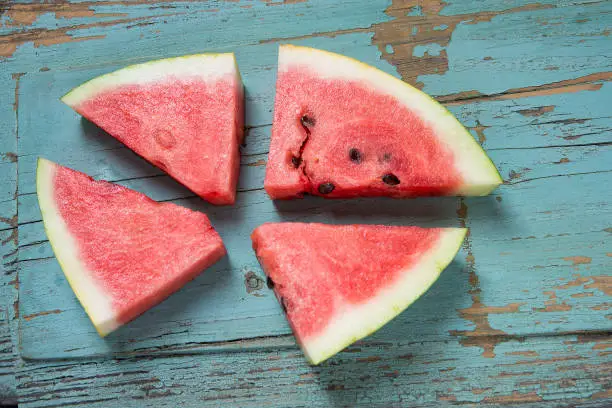 Four watermelon slices on the grungy background
