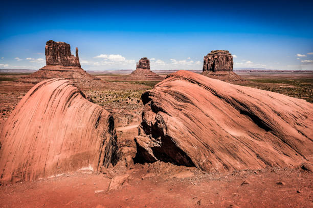 istock rocks in foreground and monument valley in background 820737152