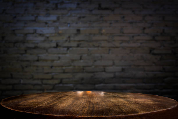 istock Selected focus empty brown wooden table and wall texture or old black brick wall blur background image. for your photomontage or product display 820741216