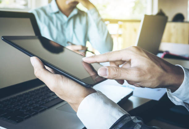 istock Business teamwork process, Businessmen hands pointing at tablet and document during explanation of new plan project data at meeting. 820741268