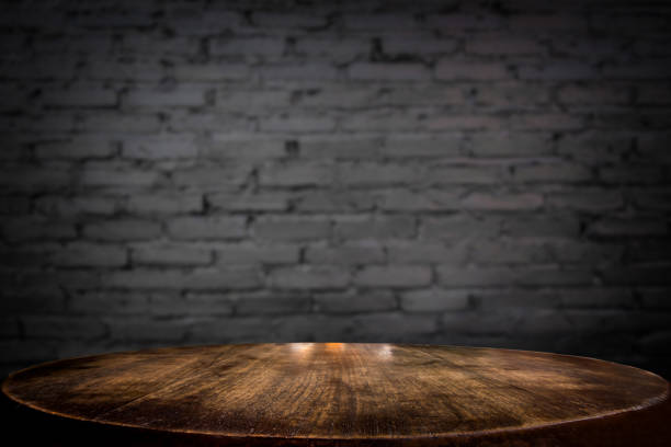 istock Selected focus empty brown wooden table and wall texture or old black brick wall blur background image. for your photomontage or product display 820741294