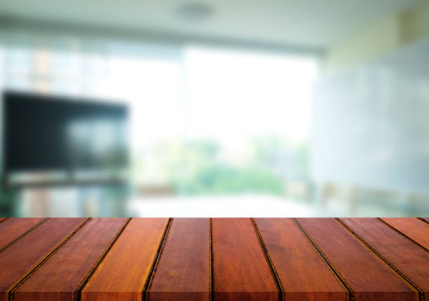 istock Selected focus empty brown wooden table and meeting room or office work blur background image. for your photomontage or product display 820741602