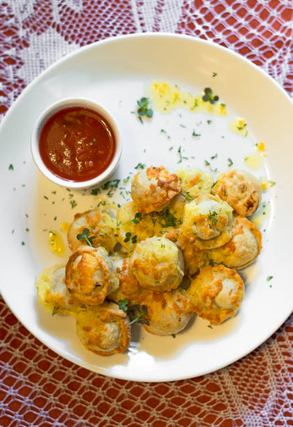 istock Traditional Russian pelmeni with cheese and tomato sauce. 820746150