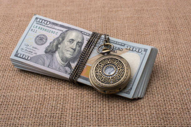 istock Pocket watch wrapped around US dollar 820752634