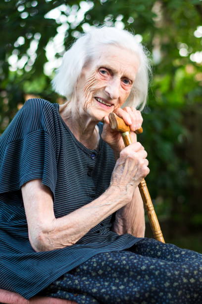 istock Cheerful senior woman with a walking cane 820753664