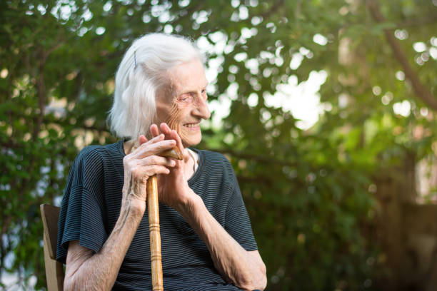 istock Cheerful senior woman with a walking cane 820754094