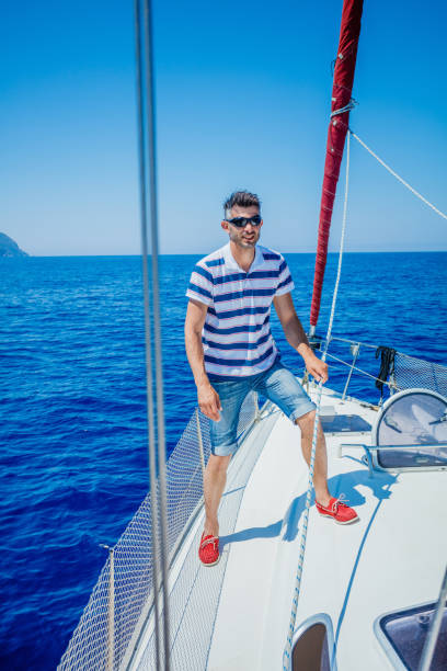 istock Young man sailing yacht 820755160
