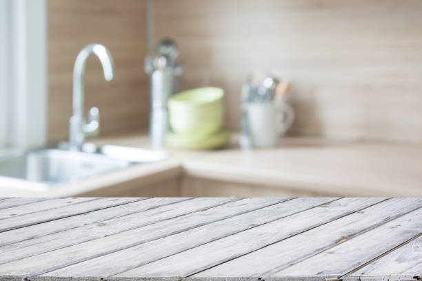istock Blurred and abstract background. Empty wooden tabletop and defocused modern kitchen background for display or montage your products. 820756800