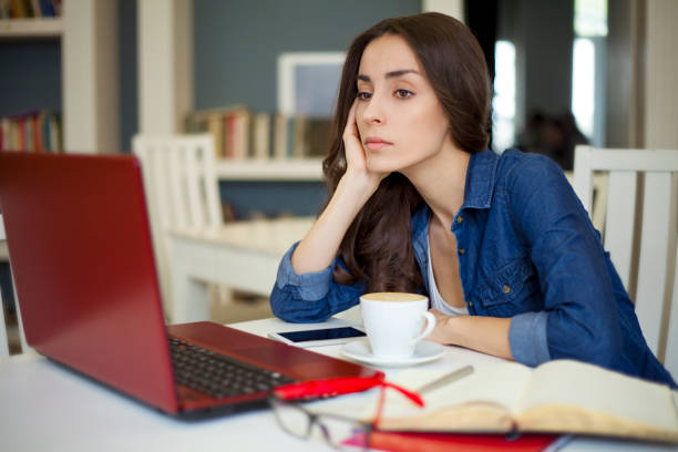 istock The girl is tired while working at a laptop in a cafe 820760968