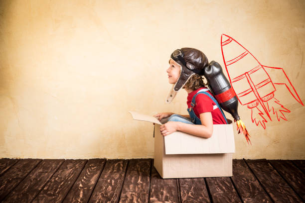 Kid playing with jet pack at home Kid with jet pack. Child playing at home. Success, leader and winner concept super fast stock pictures, royalty-free photos & images