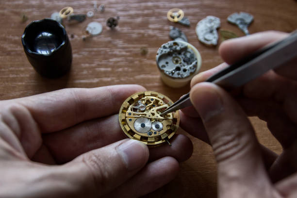 istock A watch maker is repairing a vintage automatic watch. 820765296