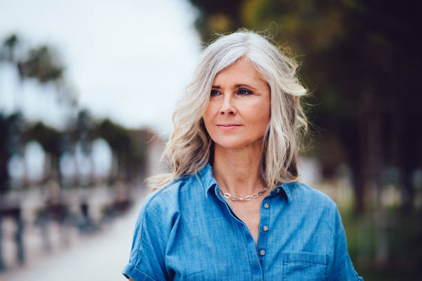 porträt von schöne ältere frau mit grauen haaren im freien - smiling women blond hair human face stock-fotos und bilder