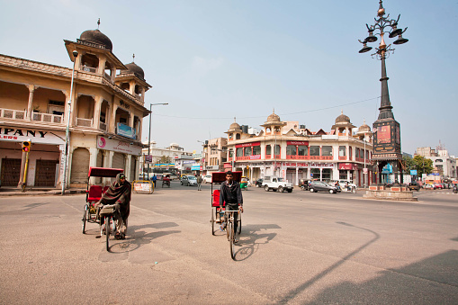 Jaipur, India - January 25, 2015: Two bike rickshaw compete in speed on the wide street on January 25, 2015. Jaipur, with population 6,664,000 people, is a capital of Rajasthan