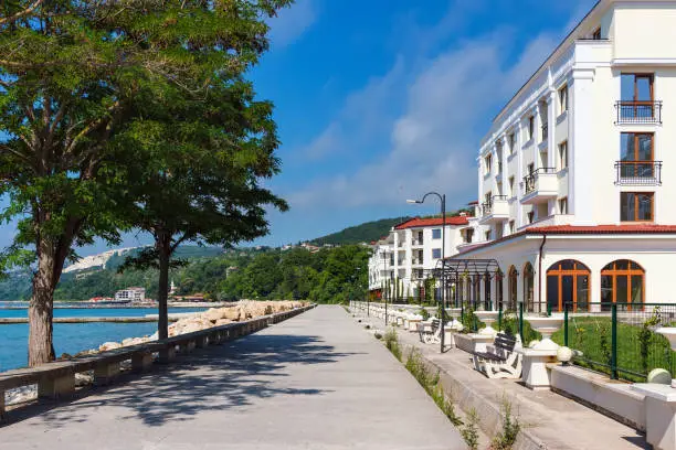 Photo of Balchik cityscape, view of city quay with apartment buildings and houses on the hills of black sea coast in Bulgaria