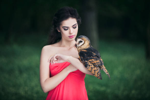istock Beautiful woman with an owl. 820769950