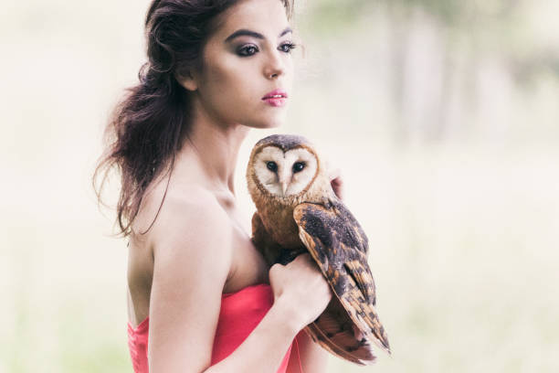 istock Beautiful woman with an owl. 820770374