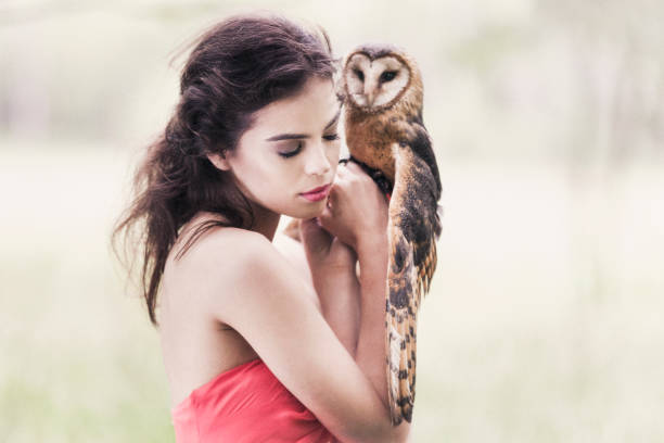istock Beautiful woman with an owl. 820770376