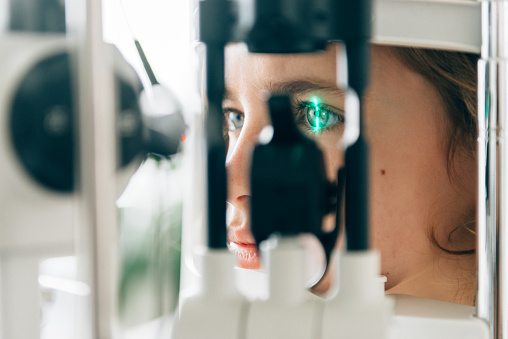 Mother with two kids at the Ophthalmologist for an eye check up