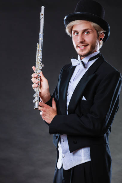 istock Elegantly dressed musician holding flute 820775002