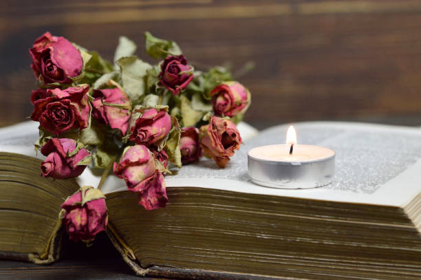 istock Candle and dry roses 820781422