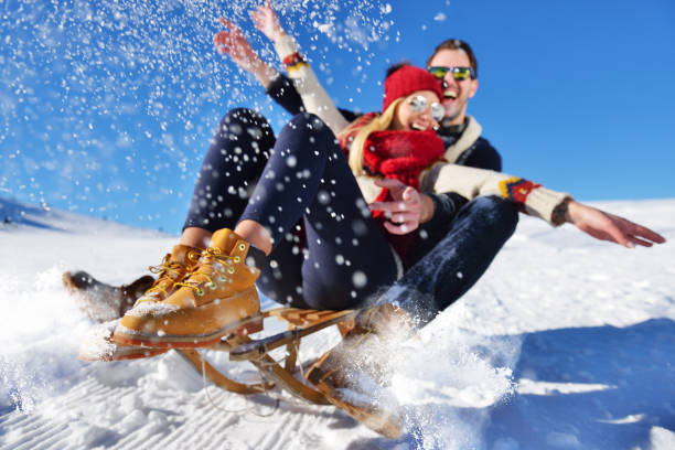 istock Young Couple Sledding And Enjoying On Sunny Winter Day 820784276