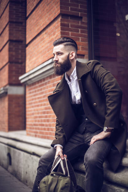 istock Young man sitting on a street 820786698