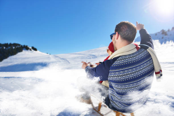 istock Young Couple Sledding And Enjoying On Sunny Winter Day 820787026