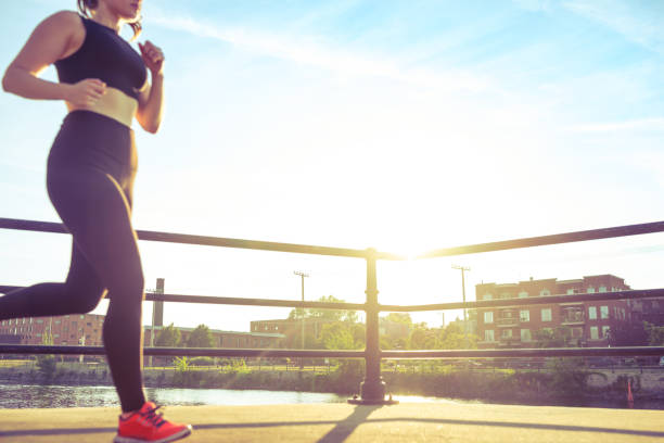 istock Young woman running at sunset 820792660