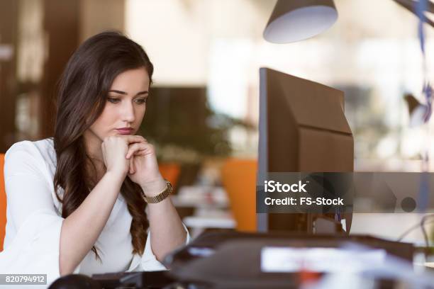 Young Tired Business Woman With Headache Sitting In Workplace Stock Photo - Download Image Now