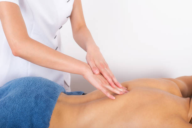 istock Young man getting back massage in massage salon 820795454