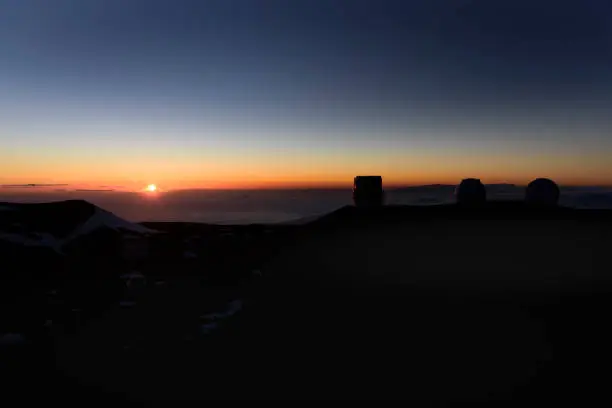 The sunset and the observatory group of the mountain top of Maunakea