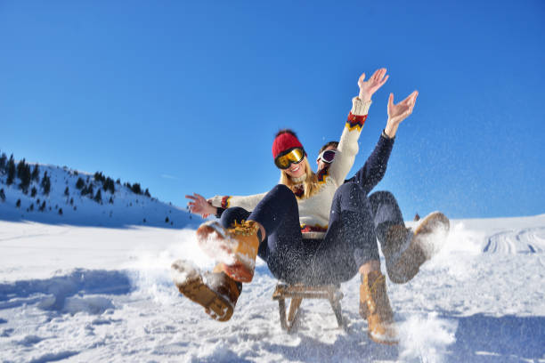 istock Young Couple Sledding And Enjoying On Sunny Winter Day 820799472