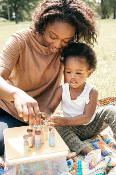 istock Playing outside the house with mom and dolls 820800880
