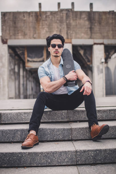 istock Young man holding penny skateboard 820805828