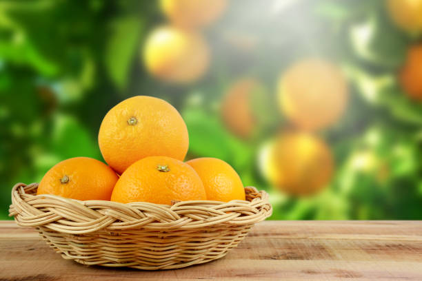 istock Fresh oranges fruit in basket on wooden. 820809610