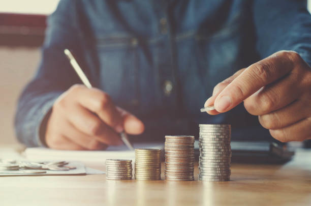 istock business accounting with saving money with hand putting coins on stack concept financial 820810158