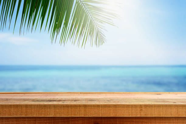 istock Beach background with palm tree and empty wooden. 820811210
