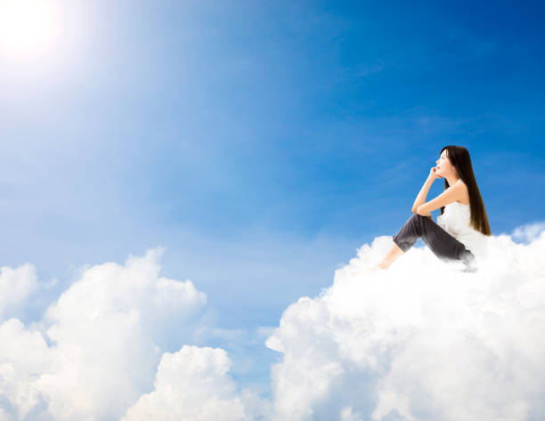 istock young woman  sitting on cloud and dreaming concept 820812644