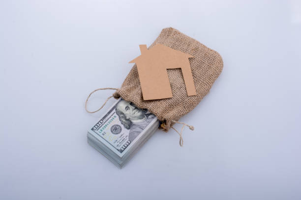 istock Paper house beside US dollar banknote 820815292