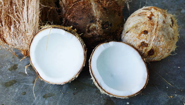 istock Close up a group of coconuts that have been cut, dumped and still have coats on the floor. 820816630