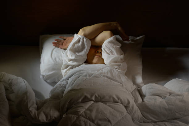 istock Woman with insomnia lying in bed with open eyes 820816748