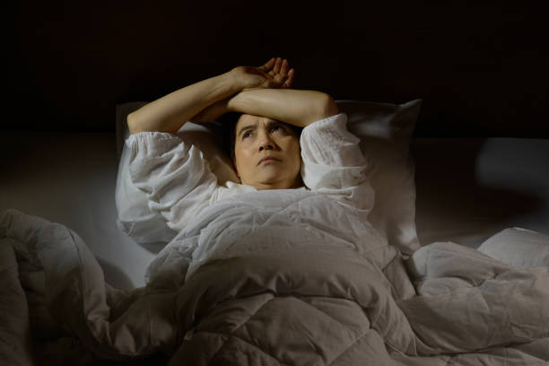 istock Woman with insomnia lying in bed with open eyes 820816830