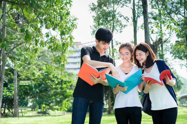 istock Young Student Group Reading Book and Using Laptop Computer Smile in Classroom Education Campus Library Outdoor 820817334