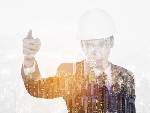 istock Double exposure of engineer with helmet against city 820821250