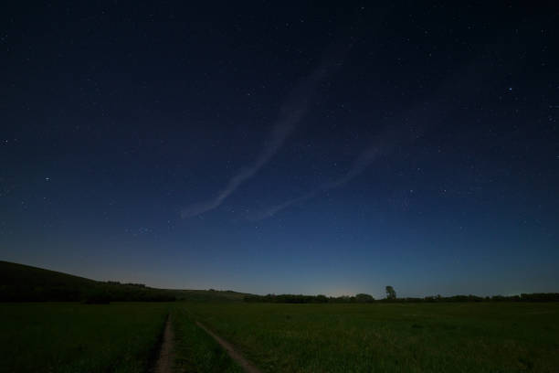 istock Night starry sky above the road in the countryside. 820822096