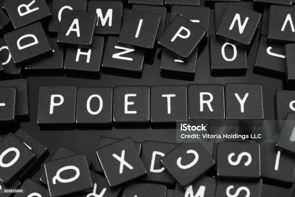 Black letter tiles spelling the word "poetry" Black letter tiles spelling the word "poetry" on a reflective background Abstract Stock Photo