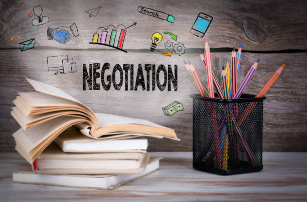 istock Negotiation. Stack of books and pencils on the wooden table. 820827894