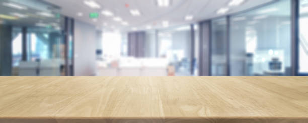 istock Wood table top and blurred bokeh office interior space background - can used for display or montage your products. 820829194